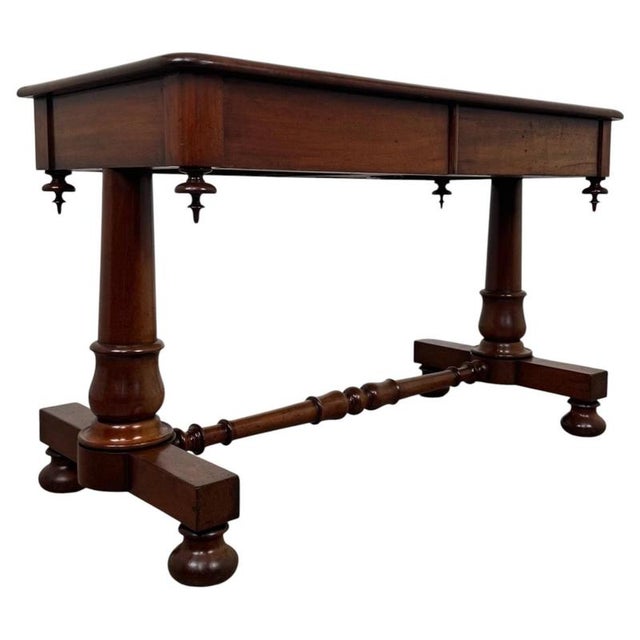 A handsome 19th-century English side table, finely crafted from mahogany and distinguished by its substantial twin-...