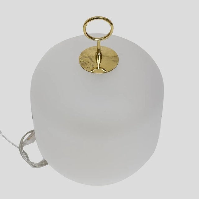 A pair of table lights “Bidone” brass circular base with a white blown Murano glass shade satin finish brass handle top....