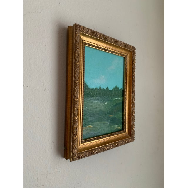 A small but vibrant landscape painting rendered in lush greens and blues, with subtle touches of yellow that bring warmth...
