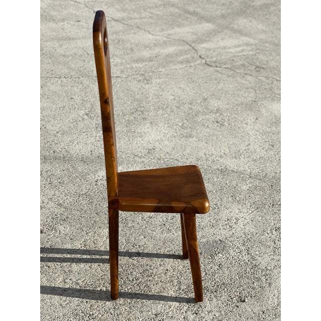 Sculptural chair in solid olive wood with high back, work of a French cabinetmaker from skela 1960. The cabinetmaking work...