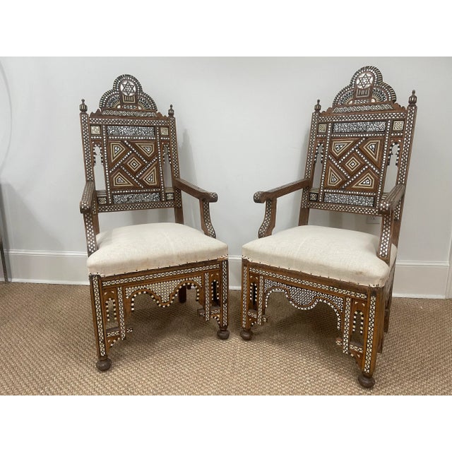 A rare and exceptional pair of 19th century Syrian armchairs adorned with geometric mother-of-pearl and ebony inlay. While...