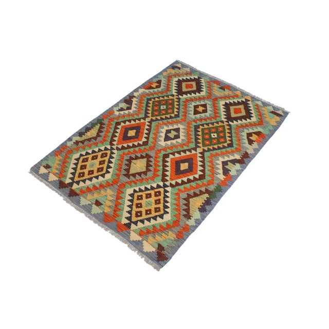 Add a touch of elegance to your home with this casual chic hand woven Tribal Kilim wool rug. Constructed on a loom by...