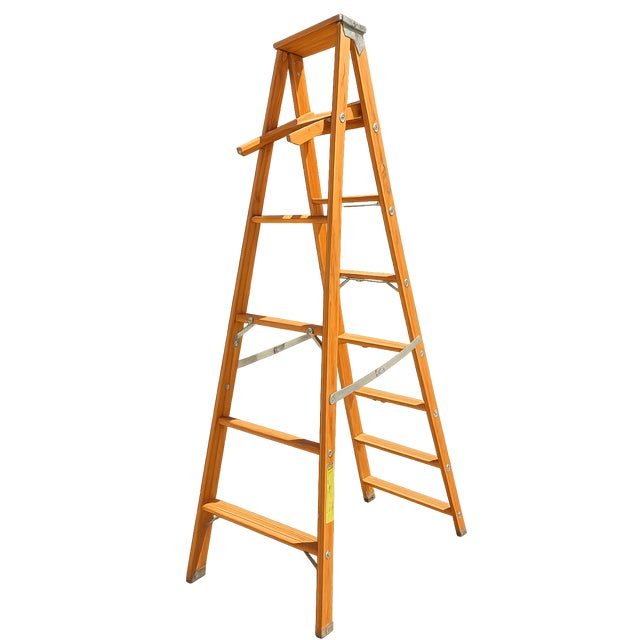 Vintage solid wood painter’s stepladder featuring the original folding paint shelf/tool tray and metal support braces....