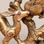 A charming Chinese carved giltwood openwork panel depicting a stylized deer beneath a pine tree, likely early to mid-20th...