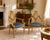 A charming pair of Louis XVI style armchairs featuring hand-painted oval medallion backs framed within elegant giltwood-...