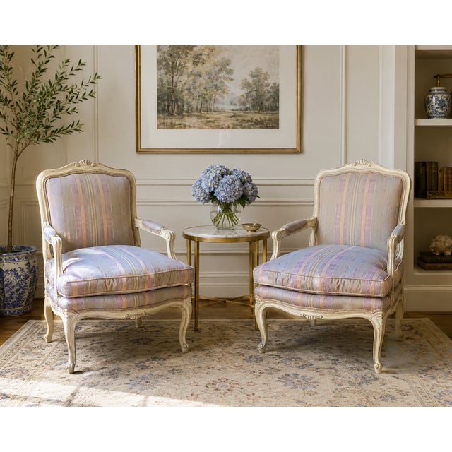 This refined pair of armchairs by Henredon is designed in the classic French fauteuil tradition, combining graceful...