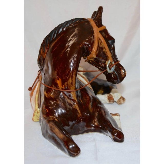 This is a tranquil horse at rest made by the Louisville Stoneware Co. of Kentucky. He is made of ceramic and has been...