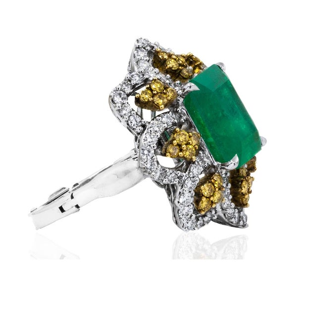 Platinum ring set with one 5.84 carat Colombian emerald, 64 round white diamonds weighing 1.28 carats and 32 round yellow...