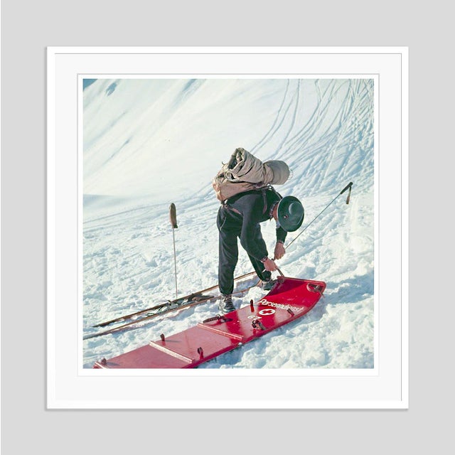 Mountain Top by Toni Frissell A member of the Klosters ski patrol checks a stretcher, Switzerland, 1951. (Photo by Toni...