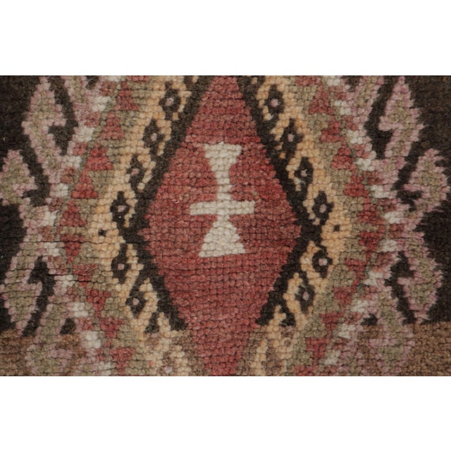 This vintage 2x3 Turkish gift-size rug, circa 1950–1959, features a pair of geometric medallions rendered in rose, ivory,...