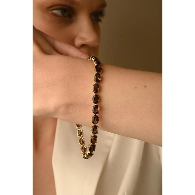 This is part of Chairish’s Fine Jewelry assortment. This Brown Quartz Tennis Bracelet in 14K gold showcases 25 endlessly...