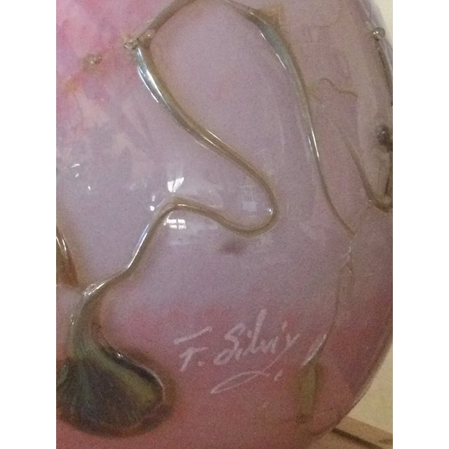 This piece is made using the three-layer glass technique. It features a white opaline core for depth, a powdery pink outer...