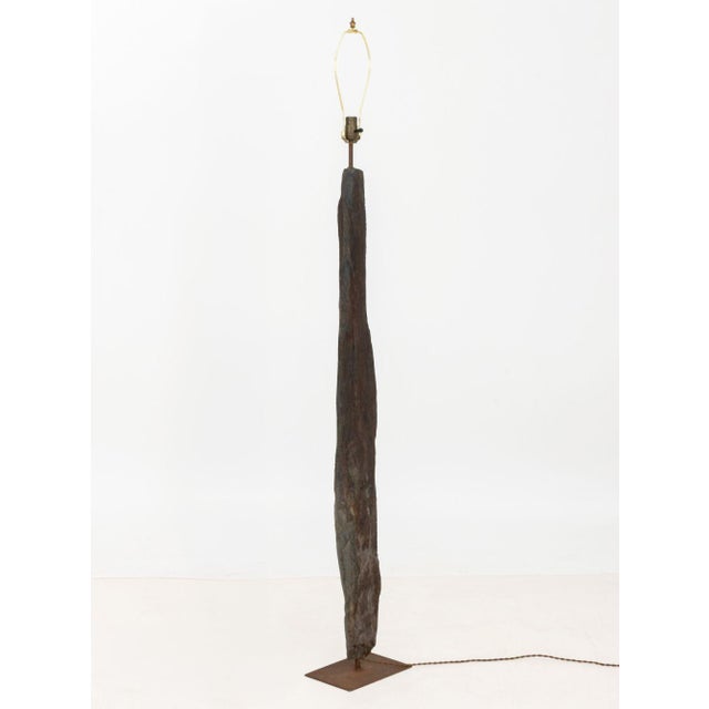 Petrified Wood Floor Lamp, mounted on rectangular iron base. 71" H x 10" W x 6.75" D. Provenance: From a One Central Park...