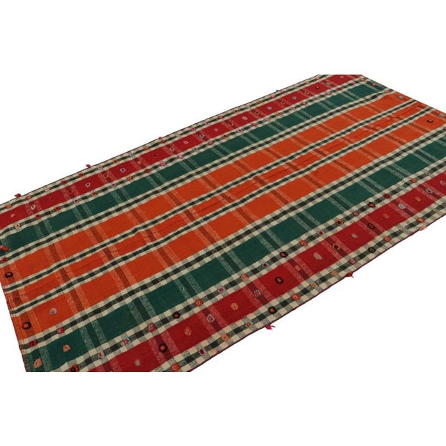 Hand-knotted in wool, this 5x8 Afghan tribal kilim rug with colorful stripes draw on Persian Qashqai kilims which favor...