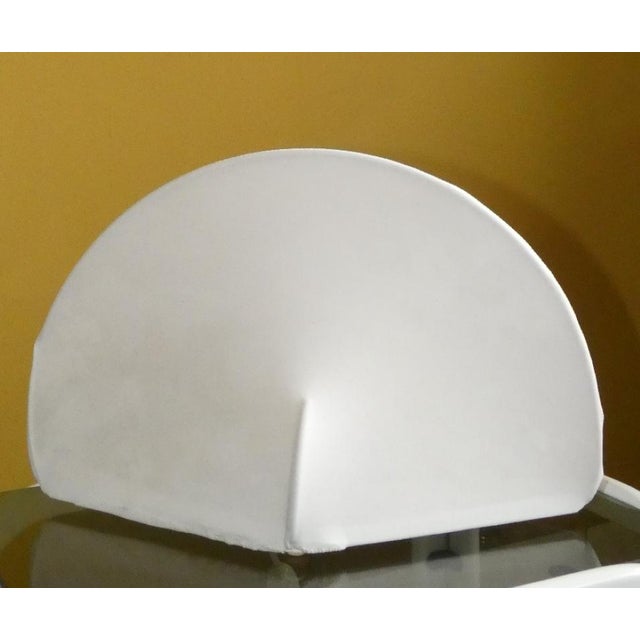 Kaori lamp in stretch fabric. It can be used as a table lamp thanks to its non-slip rubber feet, or as a wall lamp thanks...