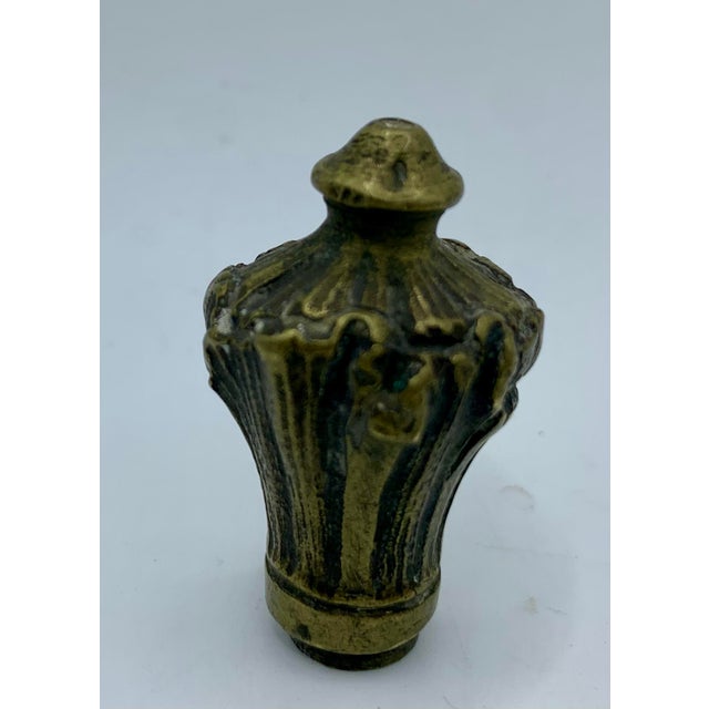 A heavy, solid cast bronze finial with a flared foliate (leaf) motif and a classic pointed cap. Sourced from a Paris flea...