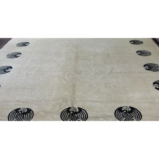 Rare Early 1900s Antique Chinese Peking Carpet — Ivory with Black Bat Motif Border This exceptionally unique early 20th-...