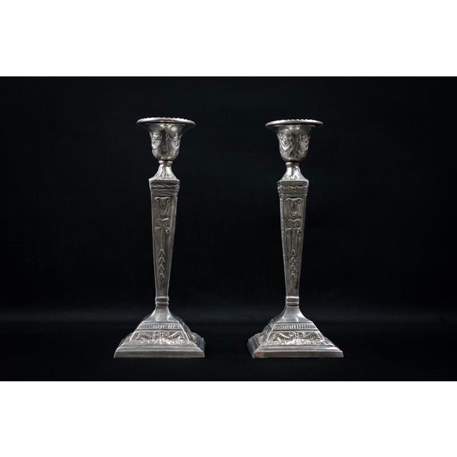 These candlesticks are likely made of silver-plated base metal using electroplating, a widespread industrial technique in...
