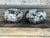 This charming pair of vintage ottomans has been newly reupholstered in a striking watercolor-inspired floral fabric...
