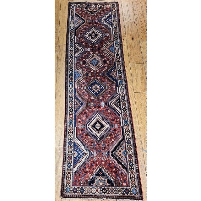 "This Vintage Persian Shiraz Yalameh Runner embodies the refined geometry and vibrant palette characteristic of Yalameh...