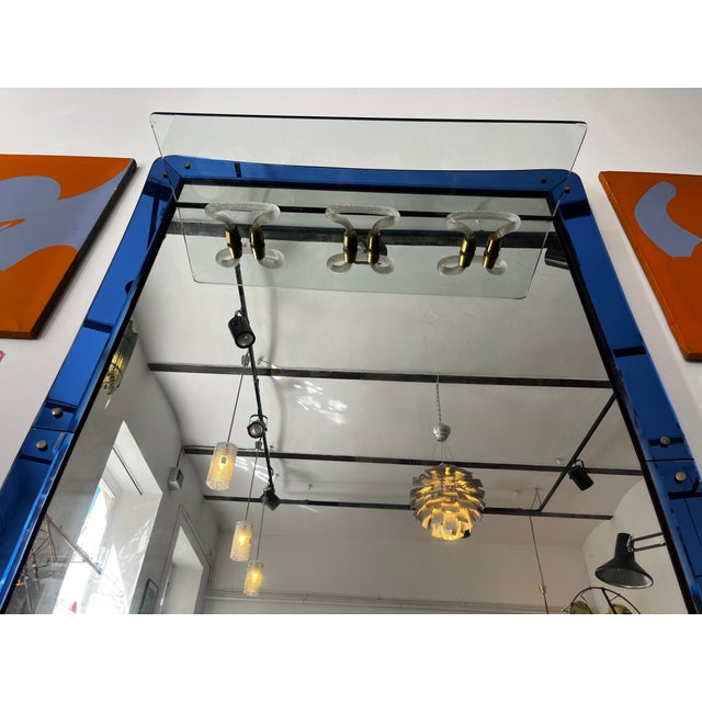 A masterpiece of glass art – a huge wall mirror with glass coat hooks and a glass shelf. The piece dates from the third...