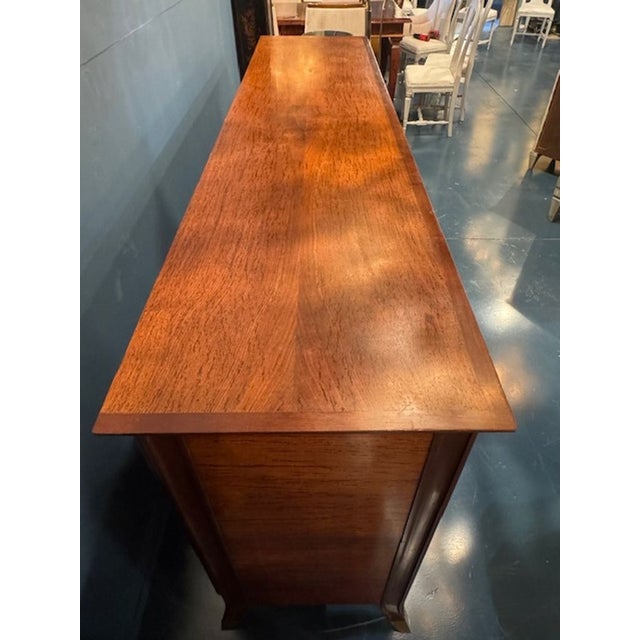 This Mid Century Art Deco Style Mahogany 4 Door Sideboard is a beautifully crafted piece of furniture that exudes elegance...