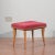 1950 stool with padded seat covered in red velvet, slightly flared and tapered legs in light wood. Original in all its...