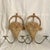 A pair of candle sconces with 2 candle holders on each sconce. Flower basket with a handle design.
