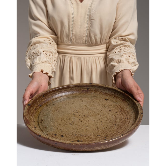 This 1970s platter from Belgium is finished in tan, worked in ceramic. Its form follows honest, well-proportioned lines...