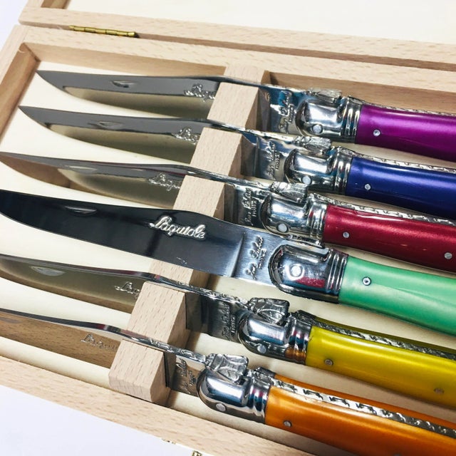 Jean Dubost Laguoile Stainless Steel Steak Knife Set, with multi color handles brand new in wood presentation box.