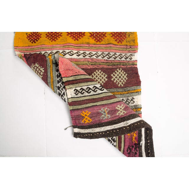 This is a vintage Turkish Oushak rug from the Mid 20th Century. The piece was hand-knotted.