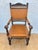 Spanish Renaissance Revival armchair crafted in oak with original leather seat and back, dating from the early 20th...