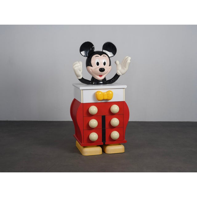 A playful and highly decorative mickey mouse chest of drawers designed by pierre colleu for starform in the 1980s. The...