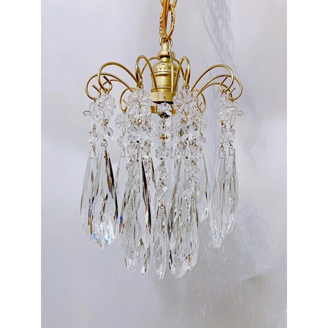 This is a small chandelier with the brass frame and hand polished cut teardrops. It has one Edison based socket that it...