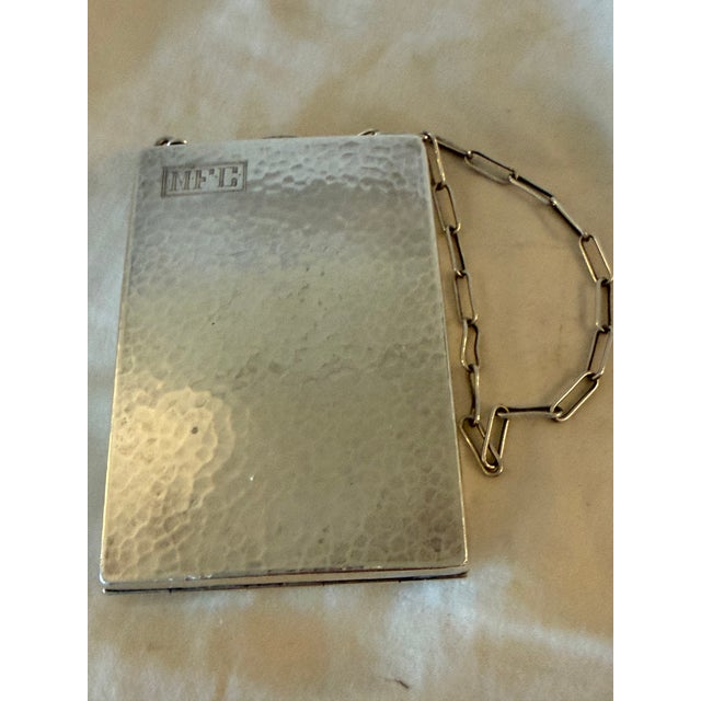 Mid-20th century European sterling silver compact mirror featuring a classic form and a chain handle for easy carrying or...