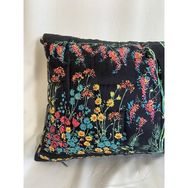 Vintage Twill Scarves in Inky Black quilted into pillows with bright floral patterns. The front showcases a striking black...