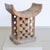 Modern African stool in traditional style. The stool is carved from wood and whitewashed. The stool has a bowl-shaped seat...