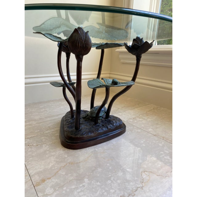 This is an elegant, high end bronze table with a glass top, featuring a water lily and frog. It's so beautifully designed...
