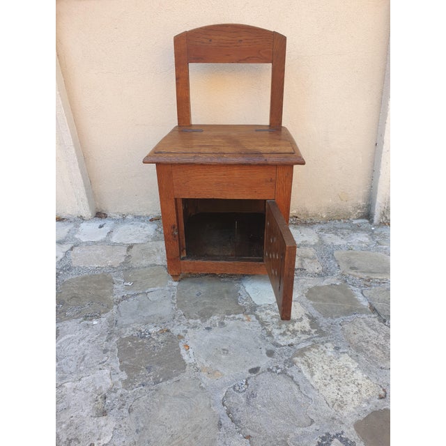 A small chair originally designed as a comfortable chair, later modified into a work chair with a warmer underneath....