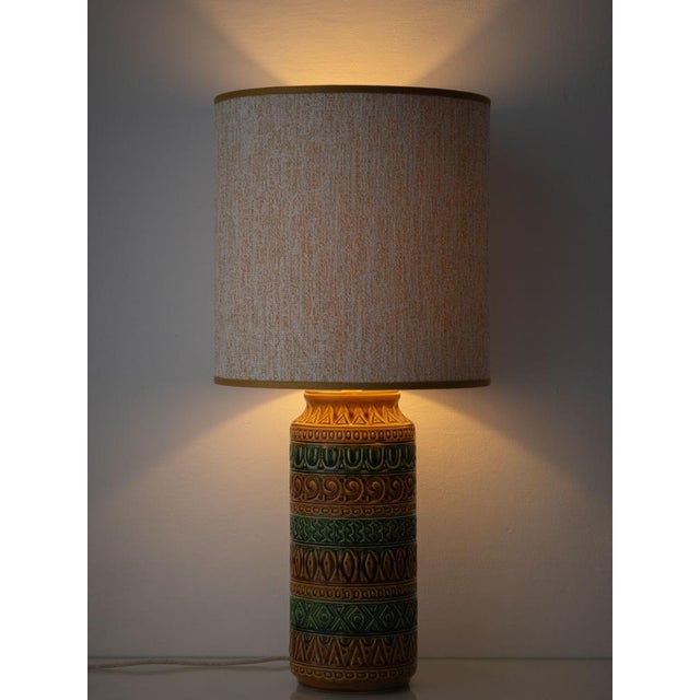 A tall West German ceramic table lamp in the incised, geometric style of Aldo Londi's Bitossi pottery, finished in earth...