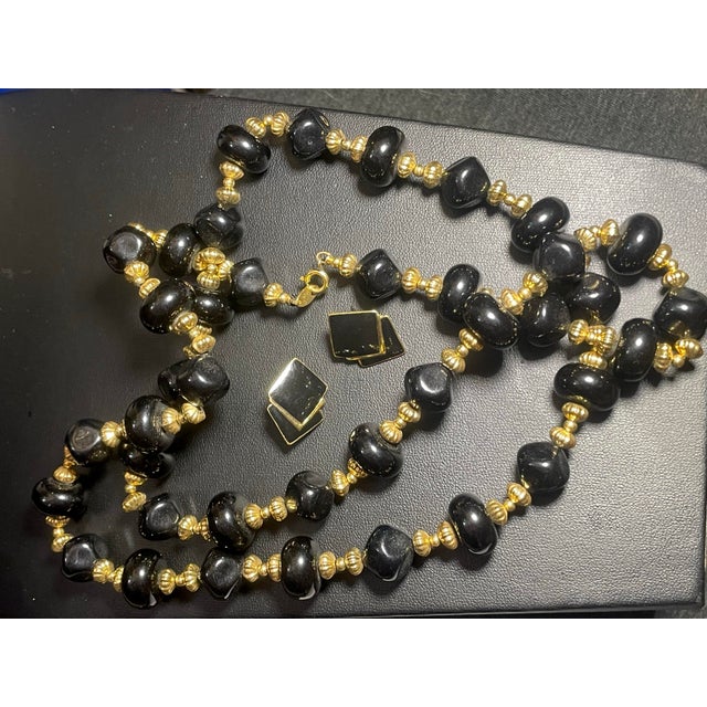 This vintage 1980s–1990s Trifari demi-parure pairs a long, dramatic bead necklace with matching post-back stud earrings in...