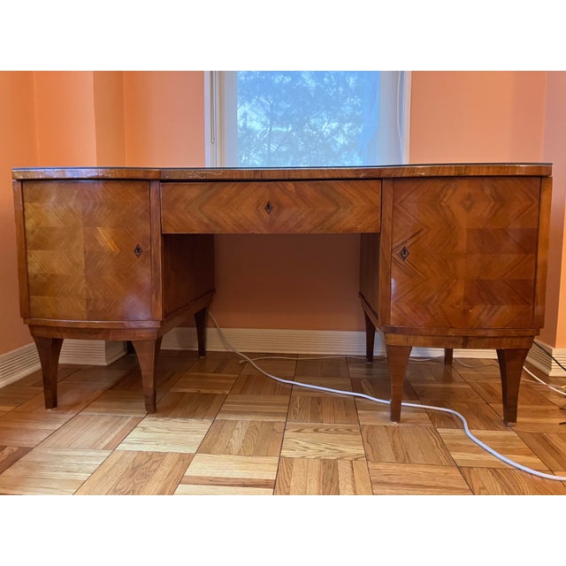 Art Deco Tanker desk with glass topper. 2 side cabinets and middle drawer. All lock with a key included. Desk is in good...