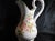 This is a large white pitcher with no makers mark. It has a pink flower design with green leaves and green trim. It has a...