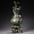 A striking Chinese bronze vase featuring an archaistic design with a rich verdigris (green) patina. The vessel has a...