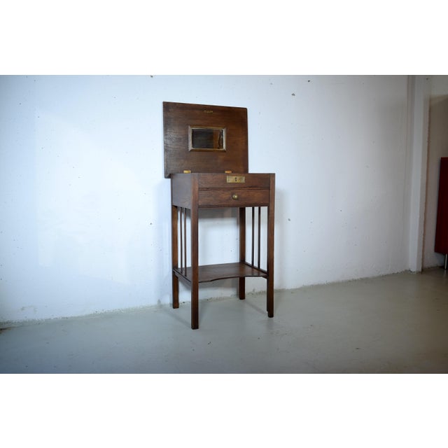 This is a restored side table from 1910 in the Art Nouveau style. The table is made of local oak and features a drawer...