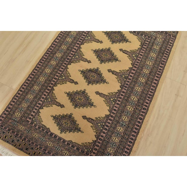 A tribal Bokhara Jaldar rug hand-knotted with fine wool on a cotton foundation. This rug features geometric medallions set...