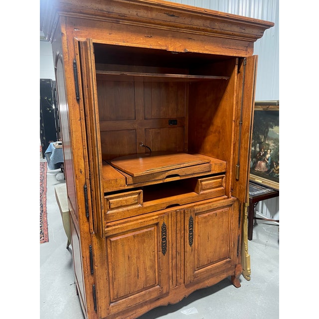 A large entertainment 4-door armoire of alder wood in a fruitwood finish by Chaddock Furniture. This is a one-piece unit....