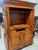 A large entertainment 4-door armoire of alder wood in a fruitwood finish by Chaddock Furniture. This is a one-piece unit....