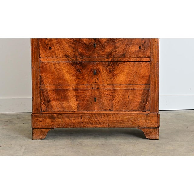 A gorgeous 19th century French walnut chest of drawers–seven drawers to be exact-designed as a classic semainier in the...