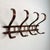 Vintage mid-20th-century bentwood wall-mounted coat rack in the style of Thonet. Made of solid wood, stained in medium to...